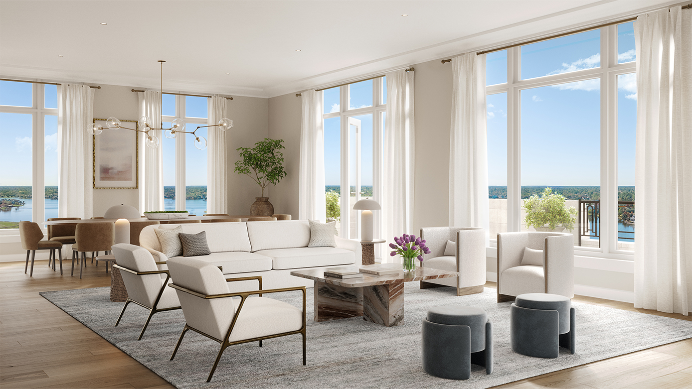 Living room with white furniture with a dining area in the background with brown furniture