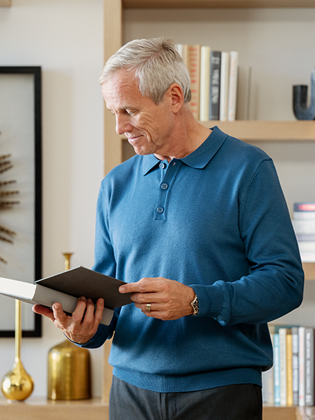 man looking in a book